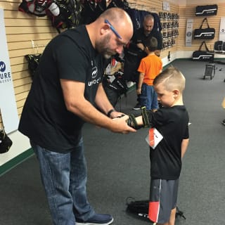 Pure Hockey Associate Fitting Young Child For Elbow Pads