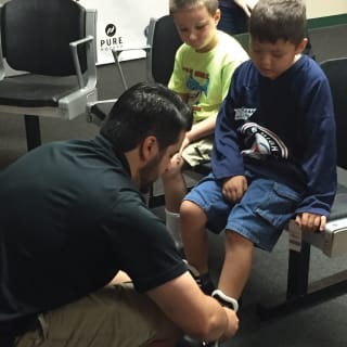 Pure Hockey Associate Fitting Young Child For Hockey Skates