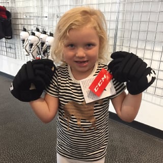 Child Posing with Hockey Gloves At Minnesota Wild Learn To Play Event
