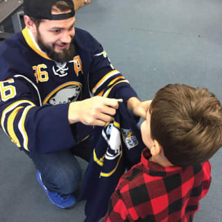 Buffalo Sabres Player Talking to Young Child at Learn to Play Event
