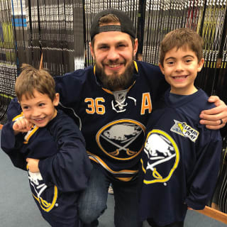 Buffalo Sabres Player Posing With Two Children at Learn to Play Event