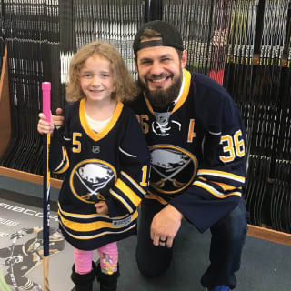 Buffalo Sabres Player Posing With Two Children at Learn to Play Event
