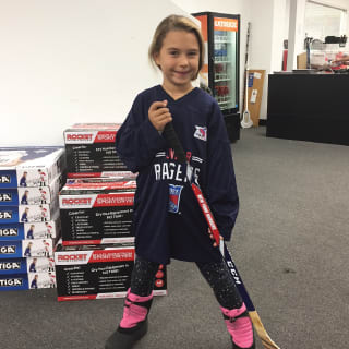 Child Posing With Hockey Stick At New York Rangers Learn To Play Event