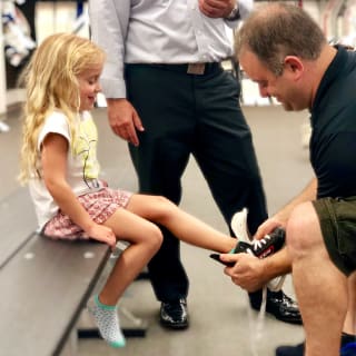 Image of Young Child Getting Fit For Ice Hockey Skates By Pure Hockey Associate