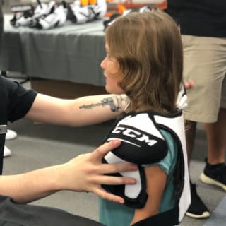 Pure Hockey Associate Fitting Young Child For Hockey Shoulder Pads