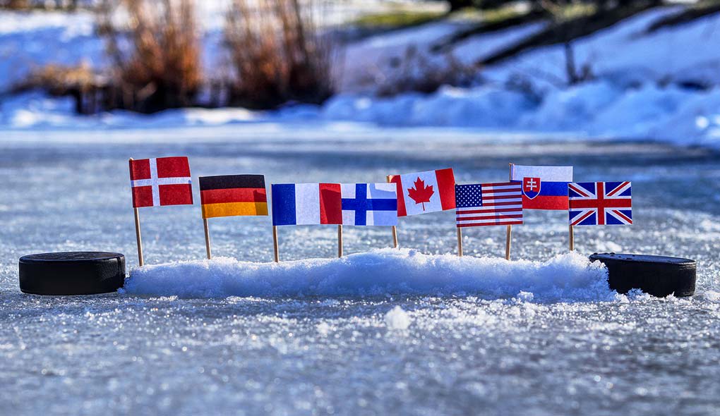 Country flags between two hockey pucks